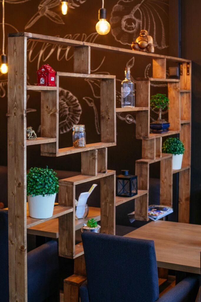 Charming cafe setting featuring wooden shelves, indoor plants, and cozy decor.