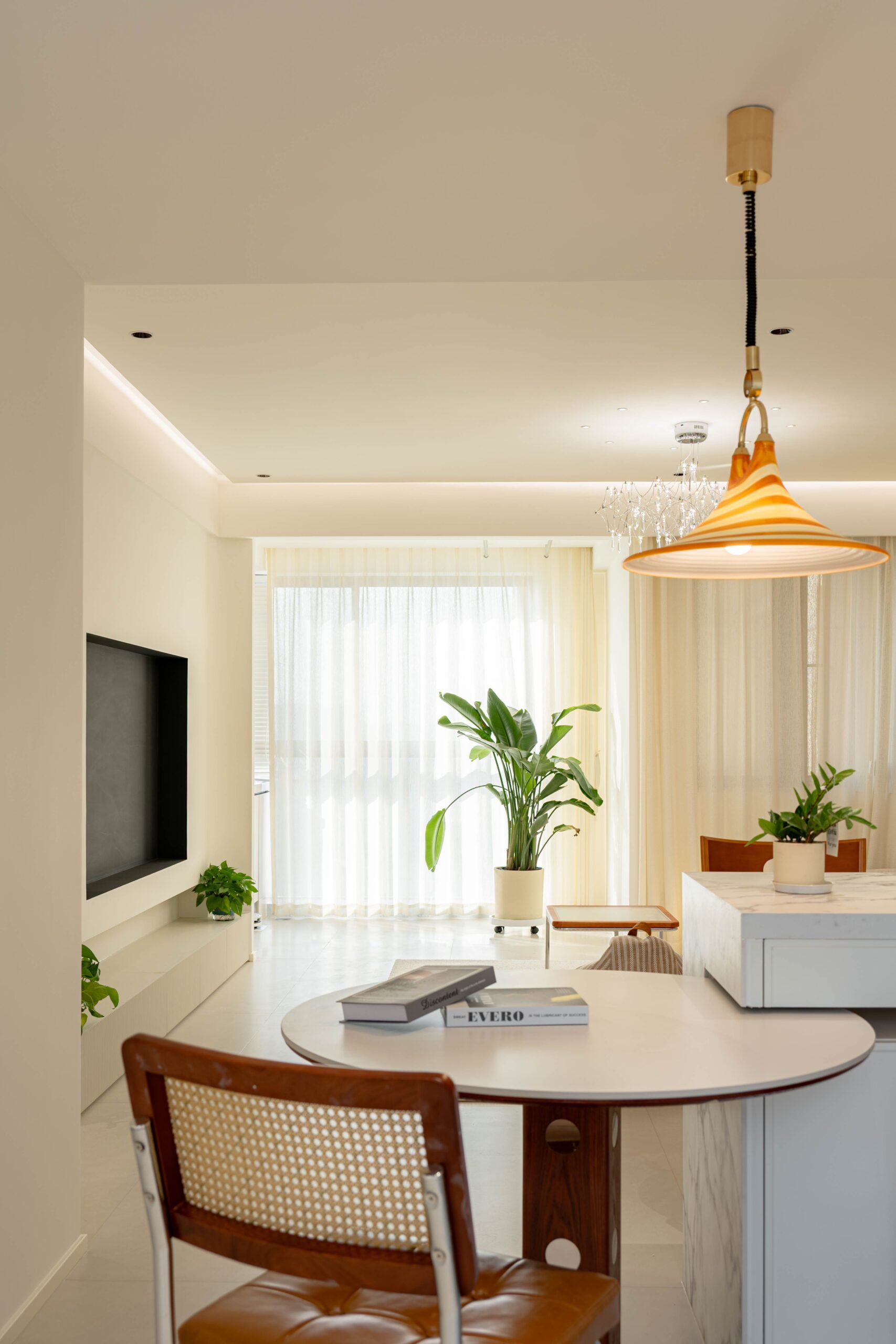 Bright, minimalist living room with plants and stylish lighting.