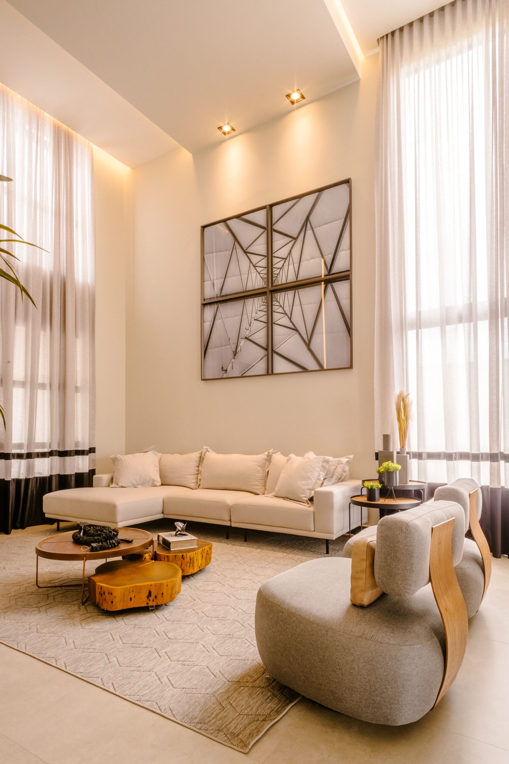 Stylish modern living room with high ceilings, minimalist decor, and neutral palette.